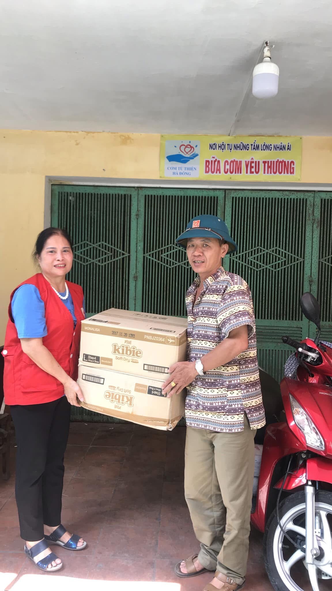 Đại diện chương trình trao bỉm đến Nhóm Cơm từ thiện Hà Đông